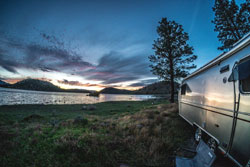 Relaxing by the lake in an RV away from the world.