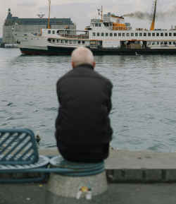 An old man sitting by the river thinking